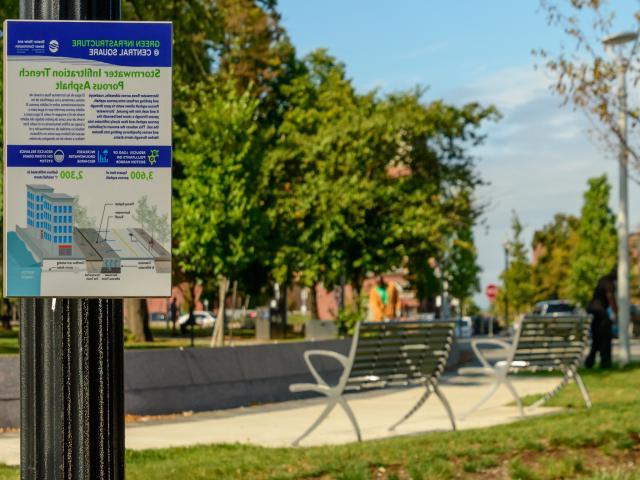 A sign for Green Infrastructure in front of a park-like setting